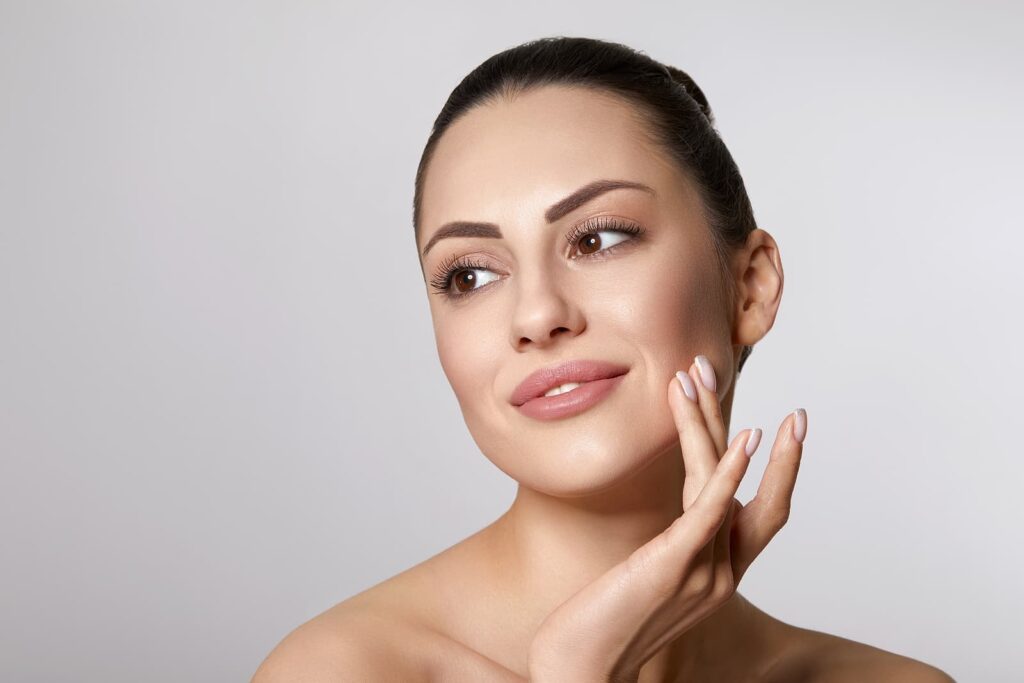 dermal fillers windsor - Woman with beauty face touching healthy facial skin