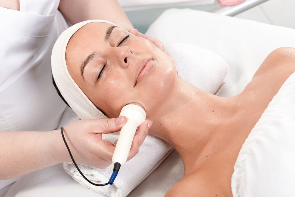 best skin specialist in Birmingham - receiving facial beauty treatment in beauty saloon
