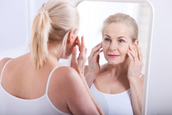 Anti wrinkle injections Birmingham - woman looking in a mirror