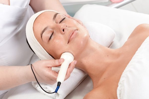 best skin specialist in Birmingham - receiving facial beauty treatment in beauty saloon
